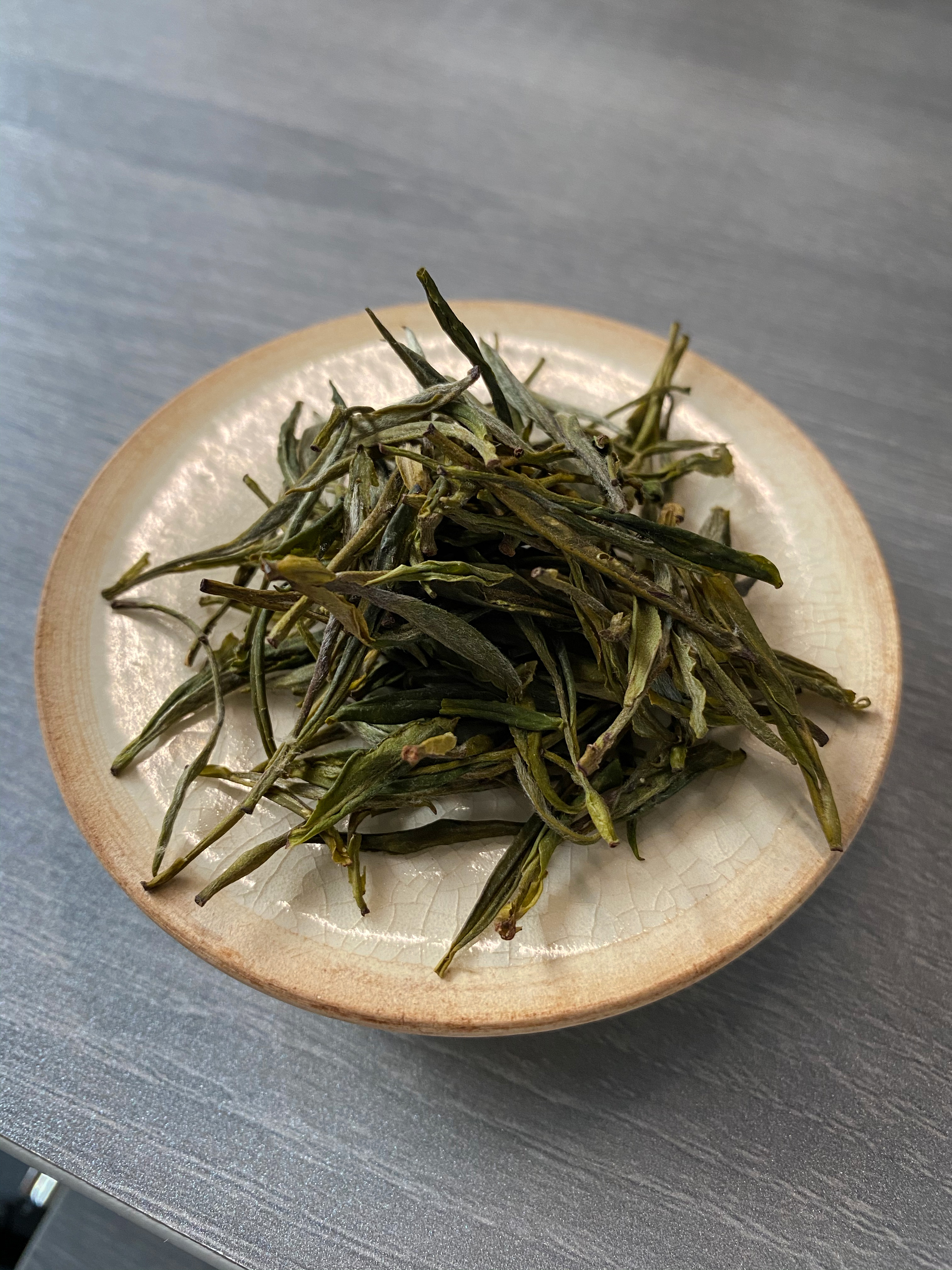 Dry leaves (quite fine pickings with covered in light, white downey) in a pile before placing in the gaiwan.